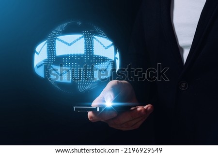 Message and email. Communication around the world via the Internet and instant messengers. The person is holding a smartphone with a hologram Royalty-Free Stock Photo #2196929549