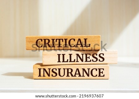 Wooden blocks with words 'CRITICAL ILLNESS INSURANCE'. Royalty-Free Stock Photo #2196937607
