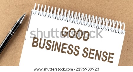 GOOD BUSINESS SENSE text on notepad with pen, business