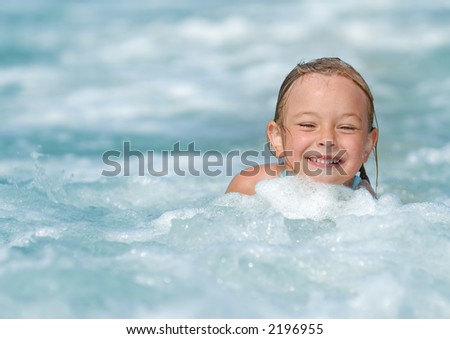 A little girl playing in the sea