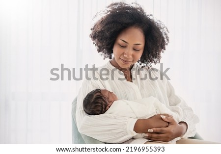 Close up portrait of beautiful young African American  mother holding sleep newborn baby in hospital. Healthcare medical love black afro woman lifestyle mother's day, breast concept with copy space.  Royalty-Free Stock Photo #2196955393