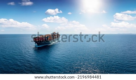 Panoramic front view of a cargo ship carrying containers for import and export, business logistic and transportation in open sea with copy space  Royalty-Free Stock Photo #2196984481