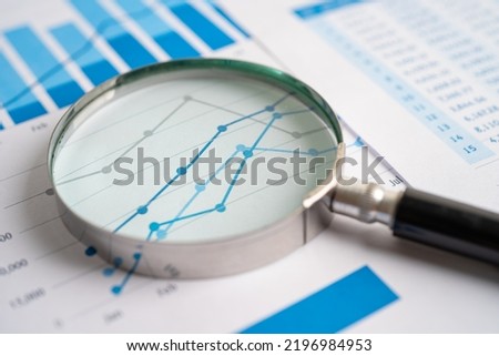 Magnifying glass on chart graph spreadsheet paper. Financial development, Banking Account, Statistics, economy, Stock exchange trading, Business office company meeting concept. Royalty-Free Stock Photo #2196984953