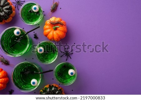 Halloween party concept. Top view photo of green floating eyes punch spiders pumpkins centipede cockroaches and black confetti on isolated violet background with empty space