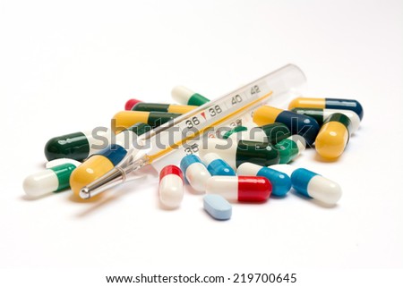Various pills with thermometer