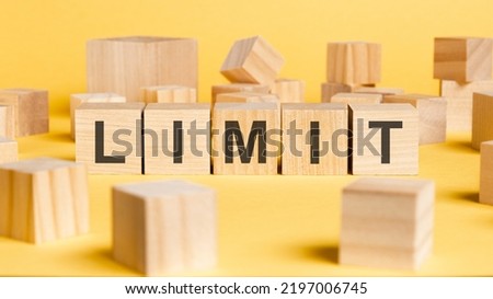 the word limit written on wooden cubes on yellow background. asset management or financial accounting concept
