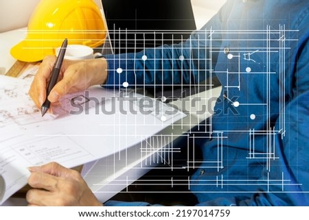 Engineers work on construction drawings and safety systems.,Building construction puts safety first. Royalty-Free Stock Photo #2197014759
