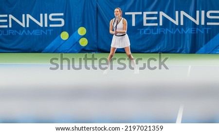 Female Tennis Player Looking at Ball with a Racquet During Championship Match. Technical Woman Athlete Receives and Lands Perfect Volley Shot. World Sports Tournament Concept. Wide Shot Photo.