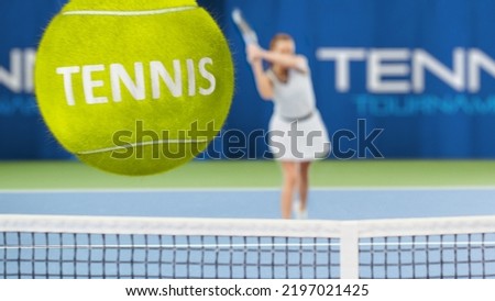 Female Tennis Player Hitting Ball with a racquet, 3D Special Effect Ball Flying towards the Screen with Tennis Written on it. Sports TV Woman Athlete Competing on a World Cup. VFX Photo Edit.
