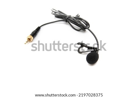 Lavalier microphone, isolated on white background. Selective focus. A lavalier microphone (also called a lavalier , clip-on microphone, or personal microphone).