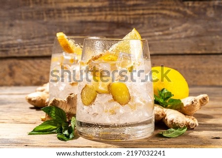 Refreshment Ginger Ale cocktail, Kombucha or Lemon Ginger iced lemonade drink. Sweet and sour alcohol drink copy space Royalty-Free Stock Photo #2197032241