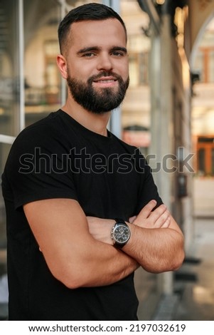 Portrait of happy handsome man near building outdoors