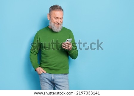 Photo of middle aged blogger read network news on device technology isolated blue color background