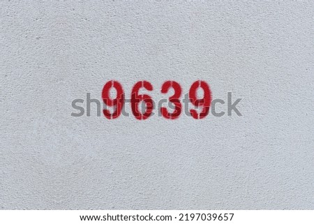 Red Number 9639 on the white wall. Spray paint.
