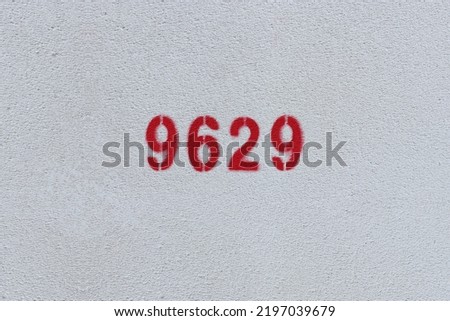 Red Number 9629 on the white wall. Spray paint.
