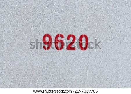 Red Number 9620 on the white wall. Spray paint.
