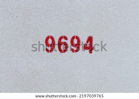 Red Number 9694 on the white wall. Spray paint.
