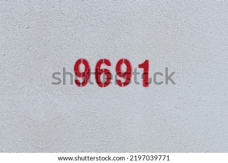 Red Number 9691 on the white wall. Spray paint.
