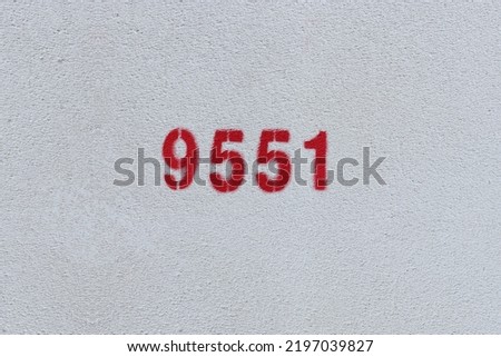 Red Number 9551 on the white wall. Spray paint.
