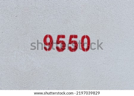 Red Number 9550 on the white wall. Spray paint.
