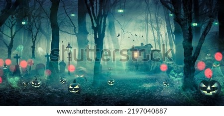 Halloween - Haunted House In Spooky Forest At Night With Pumpkins And Ghosts Royalty-Free Stock Photo #2197040887