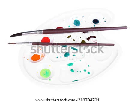 Multicoloured paint and brushes on palette isolated on white