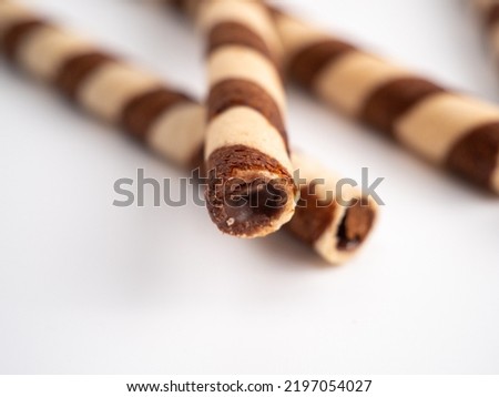 Chocolate wafer sticks or rolls, on a white background. Close-up.