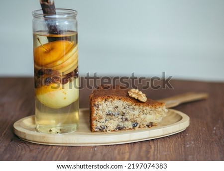 Apple cake with cinnamon, raisins, and walnuts, Autumn time with cake and slices of apples ,Healthy dessert, Selective focus.