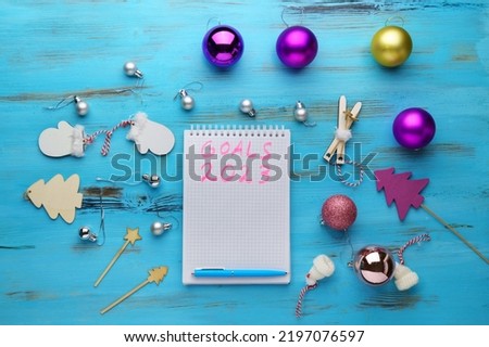 New Year 2023 words written in an office notebook. Concept in business. Plans for the new year. Flat lay. Wooden background