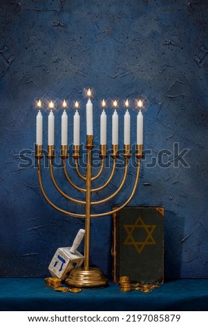 Jewish Hanukkah Menorah, book with star of David, dreidel. Holiday Candle Holder, dreidl, Talmud, or Torah. Nine-arm candlestick. Traditional Hebrew Festival of Lights candelabra. Сopy space. Royalty-Free Stock Photo #2197085879