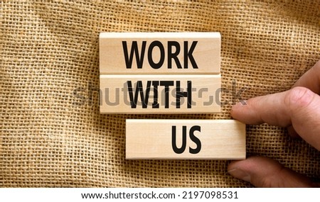 Work with us symbol. Concept words Work with us on wooden blocks on a beautiful canvas table canvas background. Businessman hand. Business, motivational and work with us concept. Copy space.