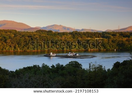 View of the Menai Straits with Snowdonia mountains in the distance. Anglesey, Wales, UK.