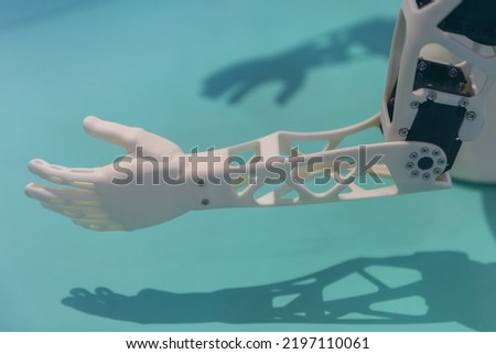 Fragment of a robot arm close-up under artificial lighting.