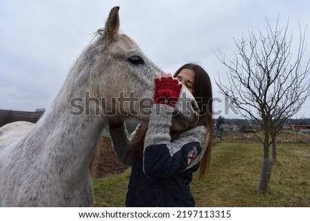 beautiful girl with white and black horses