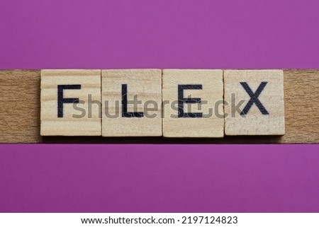 word flex from small gray wooden letters lies on a purple background