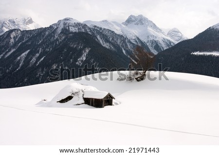 Snow covered hut in mountains (Switzerland)