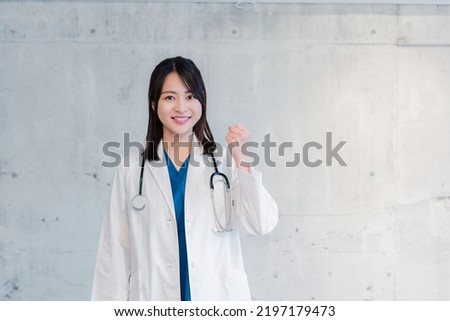 Female doctor smiling and giving a good sign