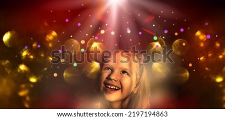 Pretty little child girl with xmas lights bokeh. Kid enjoy the holiday. Christmas and New Year concept. Happy, wishing, waiting. Merry Christmas and happy holidays!