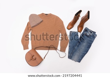 set of blue jeans,hat, sweatrer 
and accessories on white background
