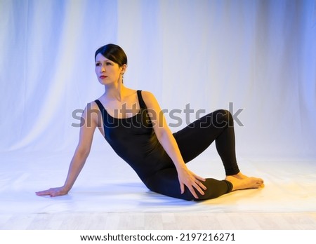 athletic woman doing pilates exercises, toning exercises for the press, crunches to strengthen the stomach, in sportswear in a yoga studio or at home