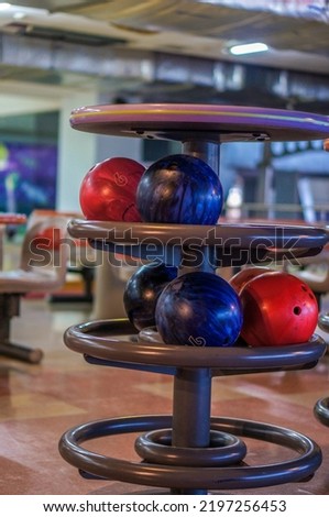 Close up of rack full of bowling balls. Many colored balls for bowling at table to store.