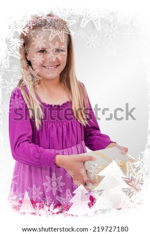 Composite image of Portrait of a happy girl receiving a present with christmas frame