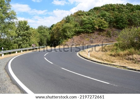 steep country road curve above Bruttig-Fankel Royalty-Free Stock Photo #2197272661