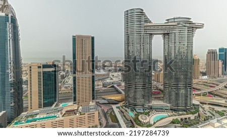 Pnorama showing futuristic Dubai Downtown and finansial district skyline aerial timelapse. Many towers and skyscrapers with traffic on streets. City walk district on a background
