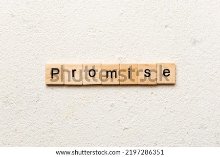 Promise word written on wood block. Promise text on cement table for your desing, concept.