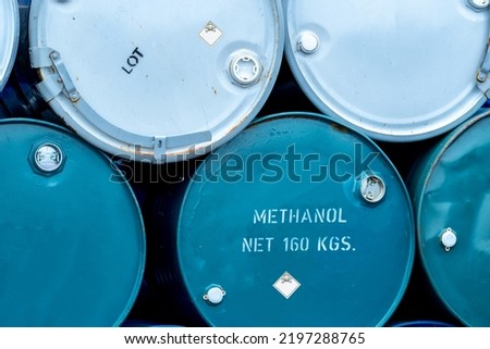 Old chemical barrels. Stack of blue methanol or methyl alcohol drum. Steel chemical tank. Toxic waste. Chemical barrel with toxic warning symbol. Industrial waste in drum. Hazard waste storage.