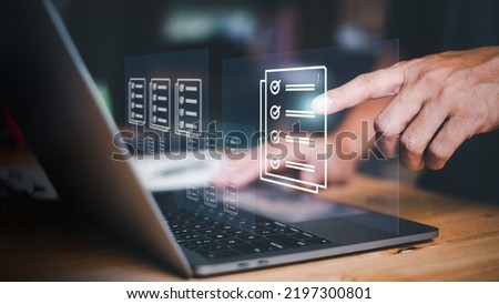Businessmen review procedures through documents containing checkbox lists, rules of conduct concepts, rules and policies, company regulatory documents, terms and conditions. Royalty-Free Stock Photo #2197300801