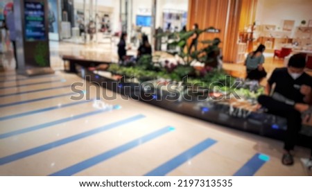 Defocused abstract background of  view of people sitting relaxed in the mall lobby.