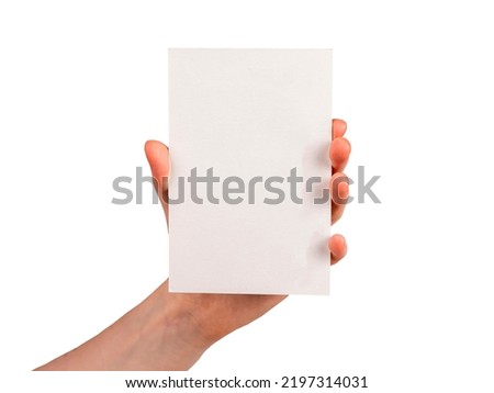 Hand holding postcard mockup isolated on white background. Template for congratulation, invitation, note. Paper in vertical position. High quality photo