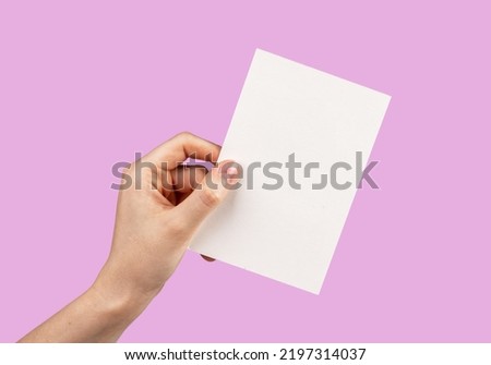 Hand holding card mockup on pink background. Template for congratulation, love confession, romantic letter. Valentines day greeting. High quality photo